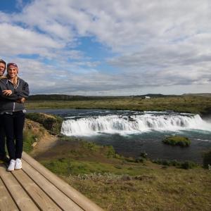 Couple stands in front of a waterfall