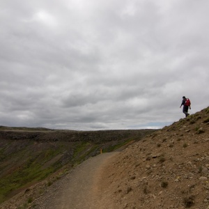 Man walks down a barren landscape