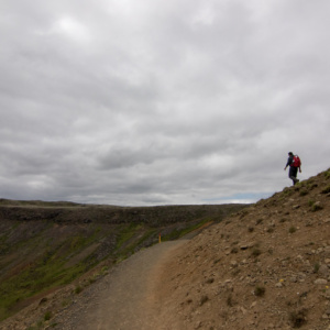 Man walks down a barren landscape